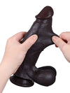 Konrad - Realistischer Dildo in Schwarz mit gleitender Haut, Breite & Hoden - 22,3 cm